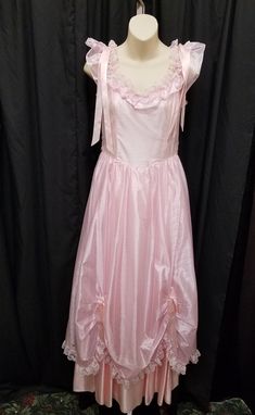 Vintage Rare 1970s Jo Ed Sophisticates Princess Pink Ruffled Formal Dress with Lace & Ribbon Accents - see pics.   Dress is in excellent condition!  Dress has a gorgeous corset bodice, ruffled neckline and delicate sleeves, a back zipper & hook closure, full skirt, and tulle and satin undercoats under the skirt. Measurements: waist 29, bust 34, shoulder to shoulder 16, neck opening 9, length from shoulder to bottom 58 inches. Vintage Ruffled Dress With Fitted Bodice For Party, Vintage Dress With Attached Cancan For Costume Party, Vintage Formal Dress With Ruffles, Retro Formal Dress With Ruffles, Sleeveless Ruffled Vintage Dress For Evening, Vintage Evening Dress With Ruffles And Fitted Bodice, Vintage Ruffled Dress For Prom Season, Evening Vintage Dress With Ruffled Fitted Bodice, Vintage Ruffle Dress For Prom Season