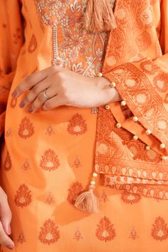 Brand: NishatCollection: Nishat Fall Fantasy Unstitched Summer CollectionFabric: Jacquard Product Detail:Ethnic Style Shirt with Dupatta SHIRTJacquard Shirt: 3 MeterEmbroidered Neckline + MotifsFabric: JacquardColor: Orange DUPATTAJacquard Dupatta: 2.5 MeterFabric: JacquardColor: Orange DISCLAIMER:* Lining, Laces, and Tassels are not included in unstitched variants.* Embellishment items in stitched outfits are subject to market availability.* The actual colors of the outfit may vary from the colors being displayed on your device. CARE INSTRUCTIONS: Extra Fabric Has Been Used For Shoot Original Color May Vary Slightly From The Picture Dry Clean Recommended Iron The Clothes At Moderate Temperature Do Not Use Bleach, Or Stain Removing Chemicals Damp Fabric Should Not Be Exposed To Sunlight Ni Unstitched Cambric Sets With Intricate Embroidery, Eid Cambric Sets With Intricate Embroidery, Orange Diwali Sets With Intricate Embroidery, Designer Cambric Palazzo Set With Intricate Embroidery, Bollywood Style Sets With Intricate Embroidery On Cambric, Designer Cambric Set With Intricate Embroidery, Bollywood Style Sets With Intricate Embroidery In Cambric, Bollywood Style Cambric Sets With Intricate Embroidery, Unstitched Embroidered Suit With Traditional Drape