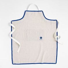 a white apron with blue trimmings and a pocket on the front that has a star in it