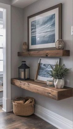 a wooden shelf with some pictures on it and a lantern in the corner next to it