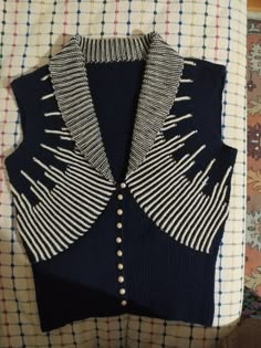 a blue sweater with white and black stripes on it