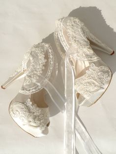 two pairs of wedding shoes with lace on them