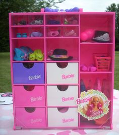 a barbie doll storage unit with pink drawers