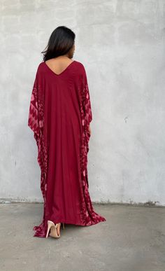 Indulge in the beauty of our classic kaftan with hand silk-screen printed fabric. This kaftan dress boasts unique patterns on high-quality rayon fabric. Its versatile design allows you to create many stylish looks, ensuring you always feel your best, whether you're at home or stepping out. Red Bohemian Kaftan With Ikat Print, Red Printed Silk Kaftan, Flowy Red Printed Kaftan, Red Silk Maxi Kaftan, Red Silk Maxi-length Kaftan, Red Bohemian Flowy Kaftan, Flowy Red Bohemian Kaftan, Red Silk Long Kaftan, Red Flowy Kaftan With Kimono Sleeves