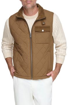 Water-resistant construction and a quilted body offer exceptional comfort in a rugged, versatile vest. 27" length Stand collar Water-resistant 100% polyester Machine wash, tumble dry Imported Winter Utility Nylon Vest, Nylon Outdoor Vest Outerwear, Nylon Vest For Fall Outdoor Activities, Nylon Vest For Outdoor Activities In Fall, Cold Weather Sleeveless Nylon Vest, Sleeveless Nylon Vest For Cold Weather, Outdoor Quilted Nylon Jacket With Padded Collar, Outdoor Fall Vest With Padded Collar, Fall Outdoor Vest With Padded Collar