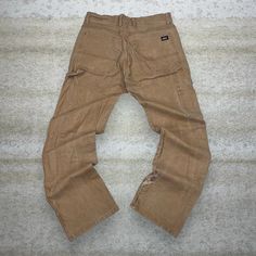 Vintage Dickies Carpenter Pants Camel Tan Canvas Baggy Fit Dungarees Work Wear Painters 90s Skate / Streetwear Great Condition: 7/10 (small marks like shown , aka some character) Men's Size:  Waist: 32" Length (inseam): 32" Leg Opening: 8" Thigh Opening: 12" Front Rise: 11.5" Vintage Jeans With Side Pockets In Relaxed Fit, Vintage Cargo Trousers For Fall, Vintage Cargo Pants With Pockets For Fall, Vintage Fall Cargo Pants With Pockets, Baggy Brown Pants With Hip Pockets, Retro Baggy Full Length Cargo Pants, Retro Baggy Pants With Side Pockets, Vintage Bottoms With Pockets For Fall, Retro Baggy Straight Leg Cargo Pants