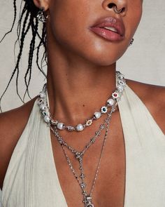 This breathtaking necklace blends pearls, gleaming silver petals, and vibrant red and green gems to imbue any utilitarian look with timeless allure. Materials: rhodium plated brass, cz stone, glass pearl Measurements: 430mm/17"in length, 70mm/2.8" in extension length. Koleen Diaz × En Route Silver Pearl Necklace With Jewels, Silver Pearl Necklaces With Jewels, Silver Pearl Necklaces With 17 Jewels, Daisy Pearl Necklace, Koleen Diaz, En Route Jewelry, Green Gems, Cz Stone, Vibrant Red