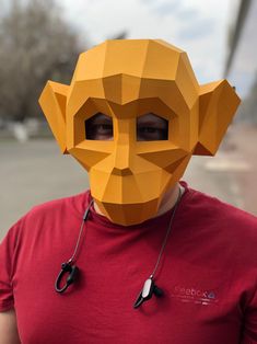 a man wearing a paper mask with an animal's head cut out on it