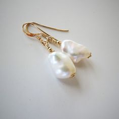 AAA Baroque Keishi freshwater pearls earrings, high gloss, natural white color, 14K Gold filled, french hooks, healing gemstone ! ... Earrings made of two beautiful Keishi freshwater pearls of 10 x 15-16 mm embellished with 14K Gold filled gold fittings. Very iridescent white natural colored pearls, undyed.    I handcrafted this classy earrings with iridescent natural white freshwater pearls, of nugget form of 10 x 15-16 mm, adorned with 14K Gold filled finding. Non-dyed natural pearls. All meta White Baroque Pearl Earrings With Pearl Charm, White High Luster Pearl Drop Earrings, White Akoya Pearl Earrings With High Luster, White Baroque Pearl Drop Earrings, Classic White Baroque Pearl Earrings, White Akoya Pearl Earrings With Pearl Charm, White Akoya Pearl Drop Earrings, White Akoya Pearl Earrings In Pear Shape, White Baroque Pearl Earrings As A Gift