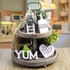 there is a small wooden tray with decorations on it and the word yum spelled out