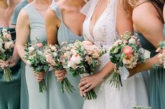 a group of women standing next to each other with bouquets in their hands,