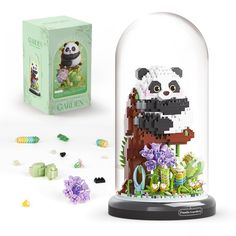 an image of a panda bear in a glass dome with flowers and plants around it