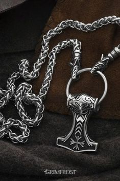 Vikings used necklaces with animals or beasts biting onto a ring where pendants were hung. This variant consists of a thick Stainless Steel chain ending in Geri and Freki, the wolves of Odin, that bite onto a pendant ring with a Stainless Steel Thor's Hammer depicting the mask of Odin and the Helm of Awe symbol. #viking #vikings #jewelry #grimfrost Geri And Freki, The Helm Of Awe, Vikings Jewelry, Helm Of Awe, Viking Pendant, Thor's Hammer, Pendant Ring, Thors Hammer, Viking Jewelry