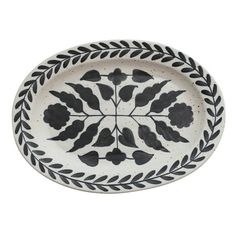 a black and white plate with flowers on the rim, isolated against a white background