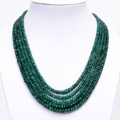 Genuine Zambian Emerald Gemstones: Each bead in this necklace is made from authentic Zambian emerald gemstones of AAA quality. Zambian emeralds are renowned for their exceptional color, clarity, and brilliance, making them highly prized in the world of gemstones. 5-Layered Design: The necklace features a luxurious 5-layered design, with each layer showcasing the beauty of the smooth rondelle emerald beads. The layered arrangement adds depth and dimension to the necklace, creating a captivating a Luxury Rondelle Beads As Gift, Luxury Emerald Rondelle Necklace, Luxury Rondelle Emerald Necklace, Luxury Green Rondelle Emerald Necklace, Rondelle Emerald Gemstone Beads Necklace, Luxury Elegant Emerald Necklace With Faceted Beads, Emerald Stone Benefits, Luxury Polished Emerald Bead Necklaces, Luxury Polished Bead Emerald Necklace