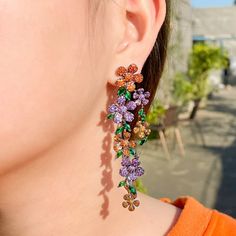 New~ Anthropologie Pave Crystal Colorful Cascading Fall Flower Earrings Elegant And Classy, A Floral Motif Features Black Metal With Orange And Purple Pave Crystal Details That Are Absolutely Stunning! Add Moody, Colorful, Sparkle To Your Evening Look. These Long, Dramatic Statement Earrings Won't Go Unnoticed! Perfect For Date Night Or Any Formal Event. Triple A Quality Cubic Zirconia Sparkles At Every Turn. Approx. 3.5"L, 1"W. Black Gun Plated, Cubic Zirconia, Post Backs Included. Nwot Anthro, Boho, Free People, Dressy, Formal, Red Carpet, Wedding, Bride, Bridesmaid, Black Diamond, Orange, Purple, Green, Holiday, Rhinestone, Punk, Rocker, Sexy, Pin Up, Party, New Anthropologie, Shashi Dancing Party, Bridal Accessories Jewelry, Engagement Party Wedding, Luxury Flowers, Wedding Bridal Jewellery, Girl Friend, Wedding Jewelry Earrings, Cz Earrings, Trendy Earrings