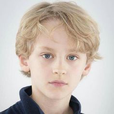 a young boy with blonde hair and blue eyes