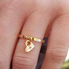 "N O N ∙ T A R N I S H ∙ G O L D ∙ I N I T I A L ∙ H E A R T ∙ R I N G 18K Gold plated on sterling silver.  Gift for her. Gift for wife. Couple ring. Christmqs gift. High-quality custom name ring that are perfect for spoiling yourself or gifting.  Dainty heart ring It will be the right choice for your daily use. Style * Minimalist jewelry * Custom initial * Letter ring * Heart ring gold * Name ring * Dainty heart ring * Initial heart ring * Personalized ring * Silver initial ring * Silver name ring *  ✔️An eternal symbol of love and remembrance combined with a personalized option for any occasion. That's what makes this dangle heart ring so sweet and soulful.  The heart charm also has a miniature heart inside.  ✔️You can also order an engraving on the back, for  example, the wedding date o Heart Ring Gold, Eternal Symbol, Personalized Gold Rings, Silver Initial Ring, Delicate Stacking Rings, Dangle Ring, Ring Initial, Gold Initial Ring, Gold Heart Ring