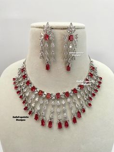 American Diamond Necklace Set / CZ Necklace/ Bollywood Jewelry/AD necklace/Reception/Wedding necklace/Silver red  All items are shipped from Brampton, Ontario, Canada. If you need your item by a certain day, please reach out to us for express delivery option before placing the order so that we can update the shipping for you. Standard shipping/delivery timeline Below are the delivery timeline estimates once the order is shipped. ---> USA delivery timeline * 3-6 business days to major urban cente Silver Ruby Necklaces For Wedding, Silver Ruby Bridal Necklace For Anniversary, Dazzling Silver Bridal Necklace With Ruby, Dazzling Silver Ruby Bridal Necklace, Red Diamond Necklace For Party, Red Cubic Zirconia Jewelry Sets For Festive Occasions, Red Diamond Wedding Necklace, Red Hand Set Necklaces For Anniversary, Formal Bollywood Jewelry In Red