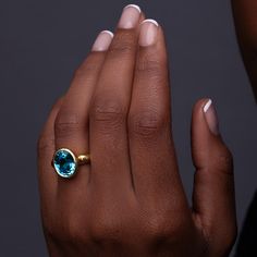 One-of-a-kind, hand-crafted ring centering 10.20 carat oval shape, fine gem quality vivid color Blue Zircon set in 18karat yellow gold bezel and 22karat yellow gold hammered setting. Size 7, can be sized upon request. Zircon might be one of the most under-appreciated colored gemstones and please do not confuse it with cubic zirconia, or CZ, an artificial product from the mid-1970s. Zircon found in Australia is the oldest mineral on earth: 4.4 billion years old. In the Middle Ages, this gem was t Gold Oval Topaz Ring With Bezel Setting, Gold Oval Cabochon Topaz Ring, Gold Topaz Oval Cabochon Ring As Gift, Gold Oval Cabochon Topaz Ring Gift, Oval Gold Topaz Ring With Polished Finish, 3d Printed Necklace, 3d Printed Earrings, Colored Gemstones, The Middle Ages