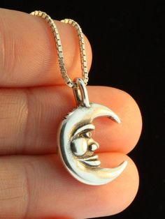 This smiling Moon Charm is cast in sterling silver. It is 7/8 inch high and fully detailed both front and back. All Marty Magic Charms and Pendants include an 18 inch (46cm) box chain. If you would prefer a different length of chain please feel free to contact me. This item usually ships the same or next business day. All Marty Magic Jewelry is packaged in a beautiful box, embossed with the gold foil Marty Magic dragon logo. Perfect for any occasion. Designed in Santa Cruz, California by Marty M Silver Half Moon Jewelry Engraved, Silver Half Moon Engraved Jewelry, Crescent Silver Jewelry With Sun And Moon Design, Silver Crescent Moon Charm Jewelry, Silver Moon Necklace With Oxidized Finish, Unique Silver Jewelry With Moon Charm, Collectible Round Pendant With Moon Charm, Silver Moon Shaped Symbolic Jewelry, Silver Moon Jewelry With Sun And Moon Design