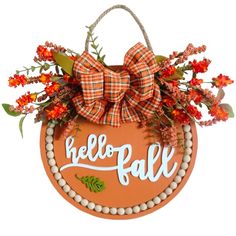 a handbag decorated with flowers and the word'hello fall'is hanging on a wall