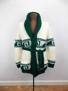 "Vintage 1970's chunky knit cardigan sweater in green and white acrylic yarn. Very good vintage condition. No tags or labels. Please refer to the following measurements when considering fit.  Length approximately 27\" Chest 38\" Sleeves approximately 24\" *Please note that vintage clothing and contemporary sizes can vary greatly. We take measurements of listed garments by laying the garment flat and then doubling the measurement. When considering whether a garment would fit, we suggest taking a similar garment from your own wardrobe and measure it lying flat as we do. Then compare the measurements." White Retro Winter Cardigan, Retro Green Winter Sweater, Green Retro Winter Sweater, Vintage Green Knit Outerwear, Vintage Green Knit Sweater, Retro Green Knitted Sweater, Retro White Knit Cardigan, Vintage Green Knit Cardigan, White Knit Retro Cardigan