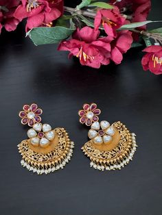 These unique ruby kundan chandbali Jhumka Earrings will certainly leave you spellbound. This pair of Jhumkas weighs about 1.4 oz.  If you are looking for an amazing trendy jumka for special occasions such as Anniversary, Engagement, Party, Wedding or for gifting , then these are a perfect choice.  Product care: Avoid contact with Chemicals such as Perfumes or any Sprays. Prevent the Jewellery from the water. Use Butter Paper or Cotton Cloth to store your Jewellery for a longer Product life. Cheap Festive Chandbali Jhumkas, Cheap Chandbali Jhumkas For Diwali, Temple Jewelry Style Chandbalis For Festivals, Temple Jewelry Pearl Earrings With Latkans For Festivals, Temple Style Pearl Earrings With Latkans For Festivals, Heavy Temple Jewelry Pearl Earrings For Celebration, Temple Jewelry Pearl Chandbali Earrings With Meenakari, Festive Chandbali Temple Jewelry Pearl Earrings, Diwali Temple Jewelry Pearl Earrings With Latkans