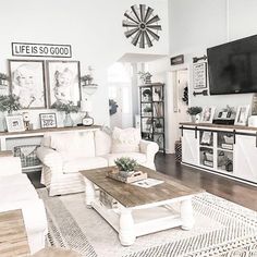 a living room filled with furniture and a flat screen tv mounted to the side of a wall