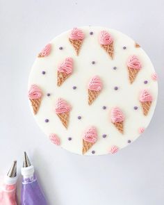 an ice cream cake with pink icing and purple sprinkles on it