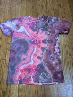 a t - shirt that has been dyed with different colors and patterns on the front