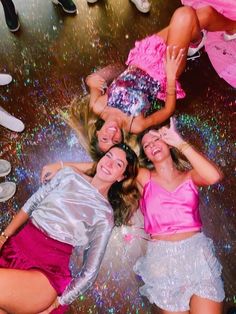 three women in pink and silver outfits posing for the camera