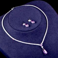 A beautiful two-piece bridal jewelry set with an incredible sparkle! Adorned with intricately faceted purple and clear cubic zirconia that capture the light from every angle with a perfectly translucent appeal, the pieces are platinum plated for a flawless finish which enhances the intricate detailing and conveys a modern take on old elegance. Necklace: 16.5" (approx. 42cm) long with a secure fold-over closure; pendant is 1" (approx. 2.5cm) long. If longer is needed please leave a note at checko Purple Diamond Jewelry, Purple Diamond Necklace For Wedding, Swarovski Jewelry Set, Purple Diamond Wedding Necklace, Purple Cubic Zirconia Jewelry Sets For Gift, Purple Cubic Zirconia Jewelry Sets As Gift, Elegant Purple Cubic Zirconia Jewelry, Elegant Purple Jewelry Sets For Formal Occasions, Fine Jewelry Lavender Cubic Zirconia Jewelry