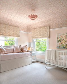 a baby's room with a crib, dresser and window in the corner