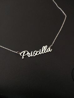 "Silver Name Necklace For Women, Personalized Jewelry, Custom Name Necklace, Christmas Gift,Personalized Gift For Women, Christmas Jewelry This personalized name necklace is a perfect gift for birthday, anniversary, christmas, bridesmaid, graduation, wedding, engagement, best friend, mom and sisters. The length of the necklace on the model is 17 \". DIMENSION * Upper Case: 8mm * Lower Case : 4mm LENGTHS * Between 13\" and 24\" * The open necklace laid straight & measured end to end. MATERIAL Custom Name White Gold Necklace As A Gift, Elegant Black Necklace For Personalized Gift, Minimalist Silver Name Necklace As Gift, White Gold Name Necklace For Birthday, White Gold Necklaces With Name For Gift, Black Nameplate Jewelry For Gift, Silver Sterling Engraved Name Necklace, Elegant Customized Silver Name Necklace, Personalized Black Name Jewelry