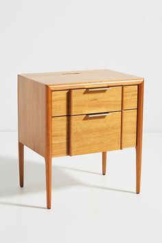 a wooden cabinet with two drawers on one side and an open drawer on the other