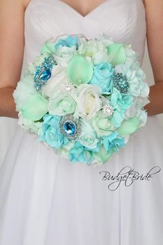 a bridal bouquet with blue and white flowers on the bride's wedding day