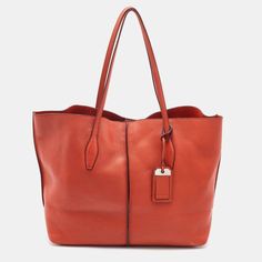 Description - Tod's Brings You This Lovely Tote That Has Been Crafted From Leather In A Vibrant Neon Orange Hue. It Has A Well-Sized Suede Interior And The Bag Is Complete With Two Top Handles, Protective Metal Feet, And A Dangling Logo Charm. Stylish And Ideal For Daily Use, This Bag Is A Worthy Buy.

 Includes - Original DustbagExterior Material - Leather Tan Calf Leather Bags With Silver-tone Hardware, Shopping Bags In Calf Leather With Silver-tone Hardware, Cognac Leather Shoulder Bag With Silver-tone Hardware, Red Business Bags With Silver-tone Hardware, Red Business Bag With Silver-tone Hardware, Modern Cognac Bags With Silver-tone Hardware, Cognac Bags With Silver-tone Hardware For Everyday Use, Cognac Travel Bag With Silver-tone Hardware, Cognac Bags With Palladium Hardware