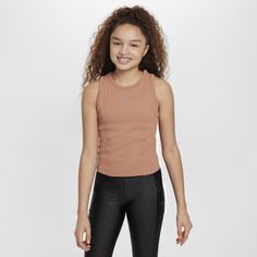 Whether you're zooming through dance tutorials or a busy weekend, this soft and stretchy ribbed crop top pulls sweat away from your body to help you comfortably move through whatever your day holds. So go ahead and perfect that viral dance step. This is your time to shine. Trendy Stretch Nike Tops, Trendy Nike Workout Tops, Trendy Nike Stretch Tops, Trendy Nike Sports Tops, Trendy Fitted Nike Tops, Nike Stretch Crop Top For Sports, Nike Stretch Crop Top For Workout, Nike Stretch Athleisure Crop Top, Nike Stretch Sports Crop Top