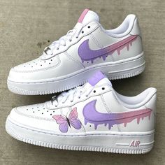 a pair of white and purple nike air force sneakers with butterflies painted on the soles