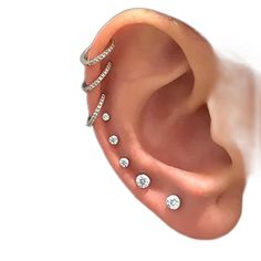 an ear with three different types of piercings on the top and bottom of it