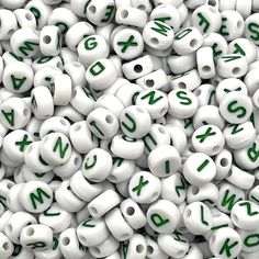 white beads with green letters and numbers on them