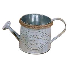 a metal watering can with rope handle and flower's & garden logo on it