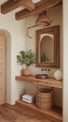 a wooden shelf with a mirror and potted plant next to a sink in a bathroom