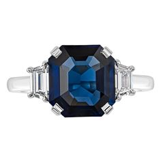 A classic and timeless engagement ring, showcasing a heated 3.73 carats emerald cut blue sapphire of Madagascar origin, set on a classic four prong setting. Flanked by two step-cut trapezoid diamonds weighing 0.40 carat total with approximately F color and VS clarity. Made with a polished platinum mounting. Size 6.25 US, resizable upon request. Roman Malakov is a custom house, specializing in creating anything you can imagine. If you would like to receive a special quote on a custom piece, please message or call us. Timeless Engagement Ring, Always A Bridesmaid, Pink Sapphire Ring, Gorgeous Engagement Ring, Custom House, Blue Sapphire Diamond, Step Cut, Three Stone Engagement, Three Stone Engagement Rings