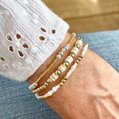 Band: Flat woven; 3/4"w; 14k gold-filled clasp & 1" extender chain; glass seed beads. Strands: Stretch style; 14k gold-filled 3mm & 4mm round beads; freshwater pearls; vinyl heishi disks; glass seed beads. Great solo or stacked. Bracelet Size Guide Neutral Seed Bead Bracelet, Disk Bracelet Ideas, Adjustable 14k Gold Filled Beaded Bracelets With Spacer Beads, Gold Heishi Beads Necklace Hand-strung, Adjustable Single Strand White Bracelet, Gold Heishi Beads Bracelet With Beaded Chain, Everyday Beaded Stretch Bracelet In Gold, Adjustable Gold Beaded Everyday Necklaces, Adjustable 14k Gold-filled Tiny Beads Necklace