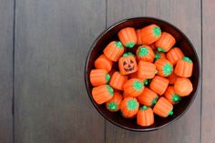 a bowl filled with lots of carrots on top of a wooden table