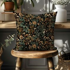 a cushion sitting on top of a wooden chair in front of a table with plants