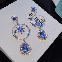 Material 14k White Gold Plated & Simulated Diamonds. Color Stones Blue/ Moon & Star Earrings Blue And Gold Earrings, Diamond Star Earrings, Moon Accessories, Fantasy Earrings, Butterfly Fashion, Egyptian Style, Moon And Star Earrings, Dog Earrings, Citrine Earrings