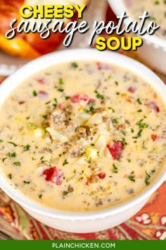 cheesy sausage potato soup in a white bowl on a colorful tablecloth with text overlay